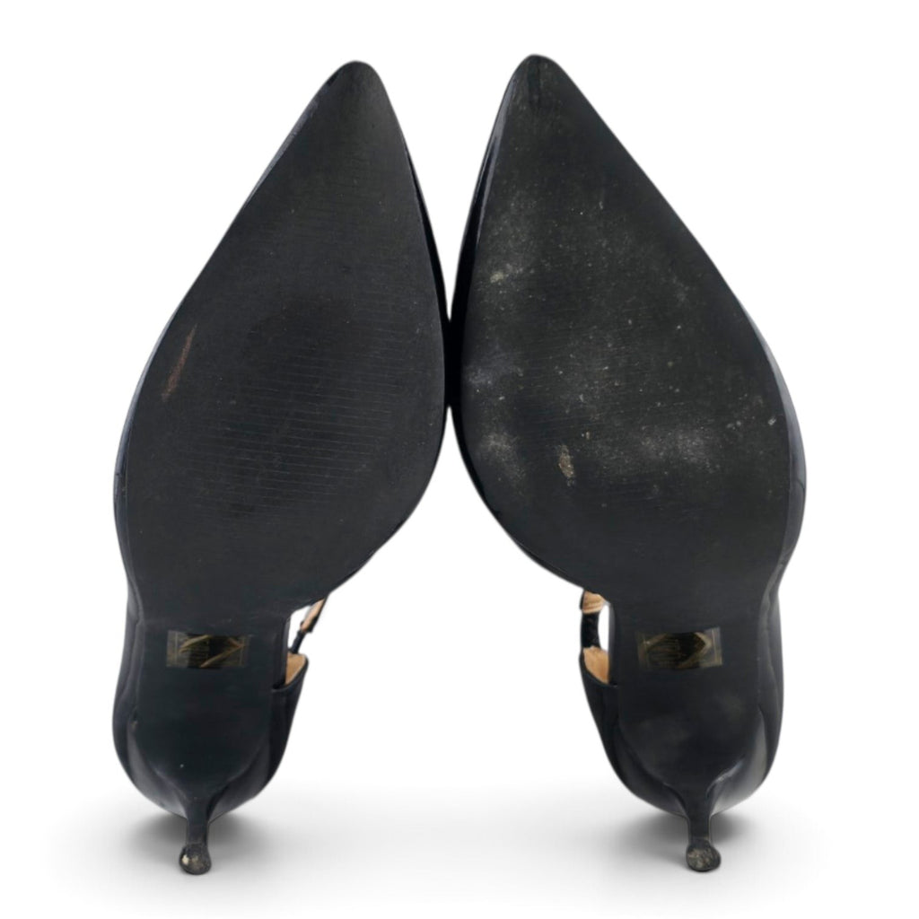 FuzzBeez black patent pointed toe stiletto pumps showing the synthetic soles from a bottom view