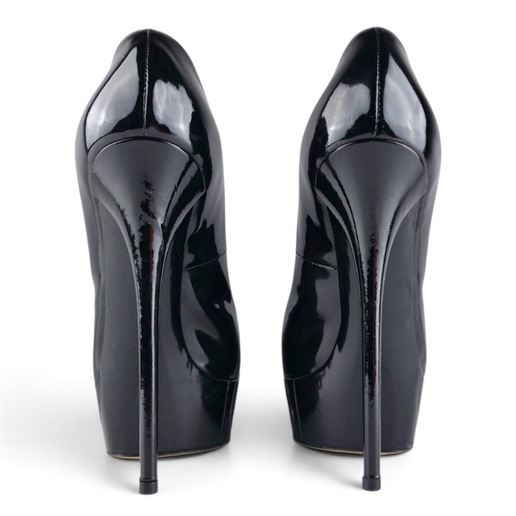 FuzzBeez Casadei black patent leather platform stiletto pumps seen from the back showing high heels