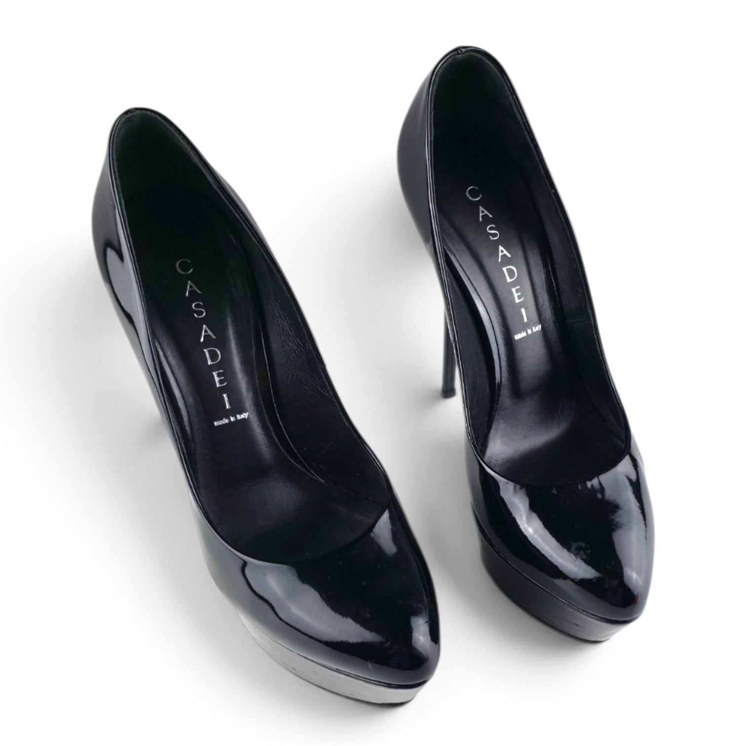 FuzzBeez Casadei black patent leather platform stiletto pumps with almond toe and high heel design.