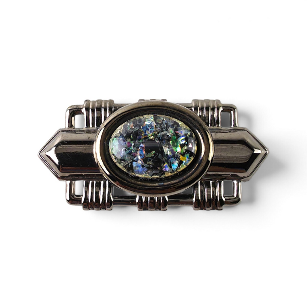 FuzzBeez Art Deco brooch featuring a gunmetal setting and an iridescent confetti foil cabochon in a geometric frame.
