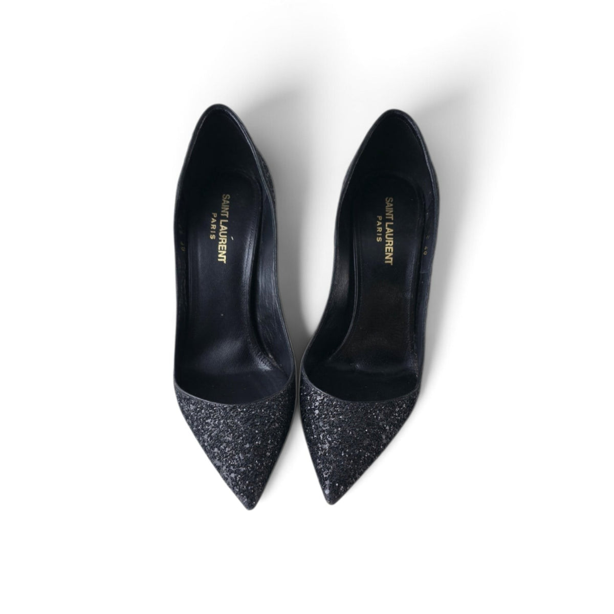 FuzzBeez Saint Laurent Zoe black glitter pointed toe stiletto pumps with leather lining, top-down view.