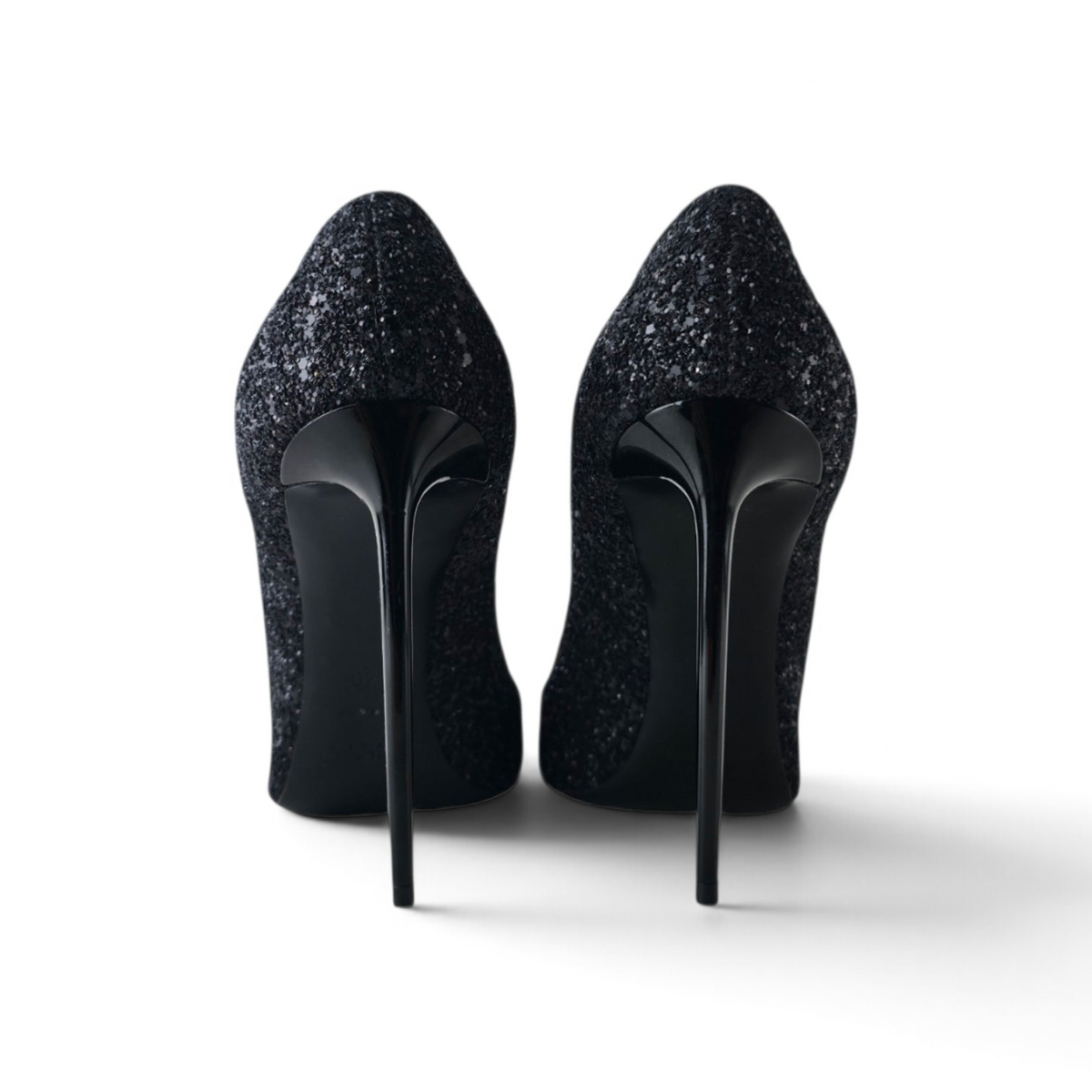 FuzzBeez Saint Laurent Zoe black glitter pointed toe pumps with high-gloss stiletto heels, back view.