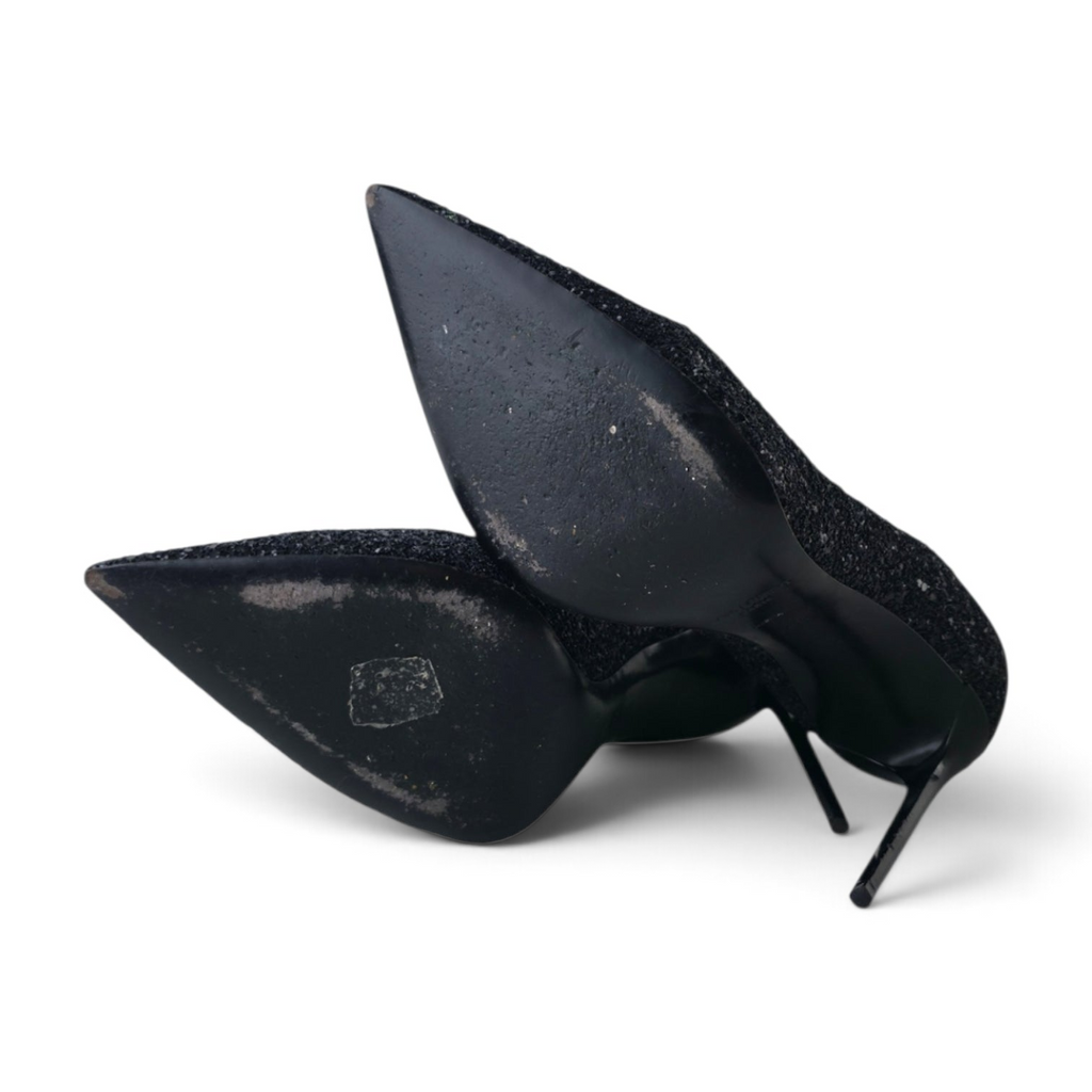 FuzzBeez Saint Laurent Zoe black glitter pointed toe stiletto pumps showing leather soles from a bottom angle