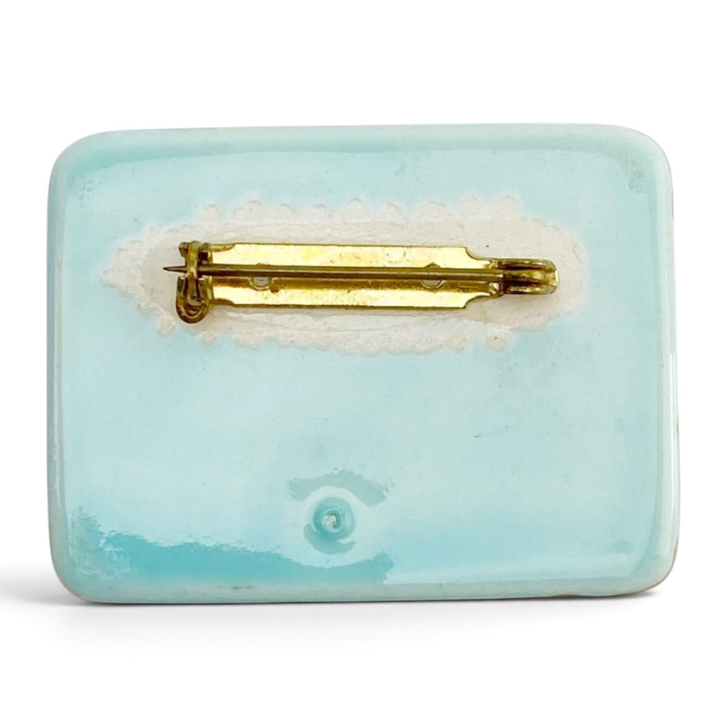 FuzzBeez vintage turquoise ceramic brooch back view showing the gold-tone metal bar pin closure.