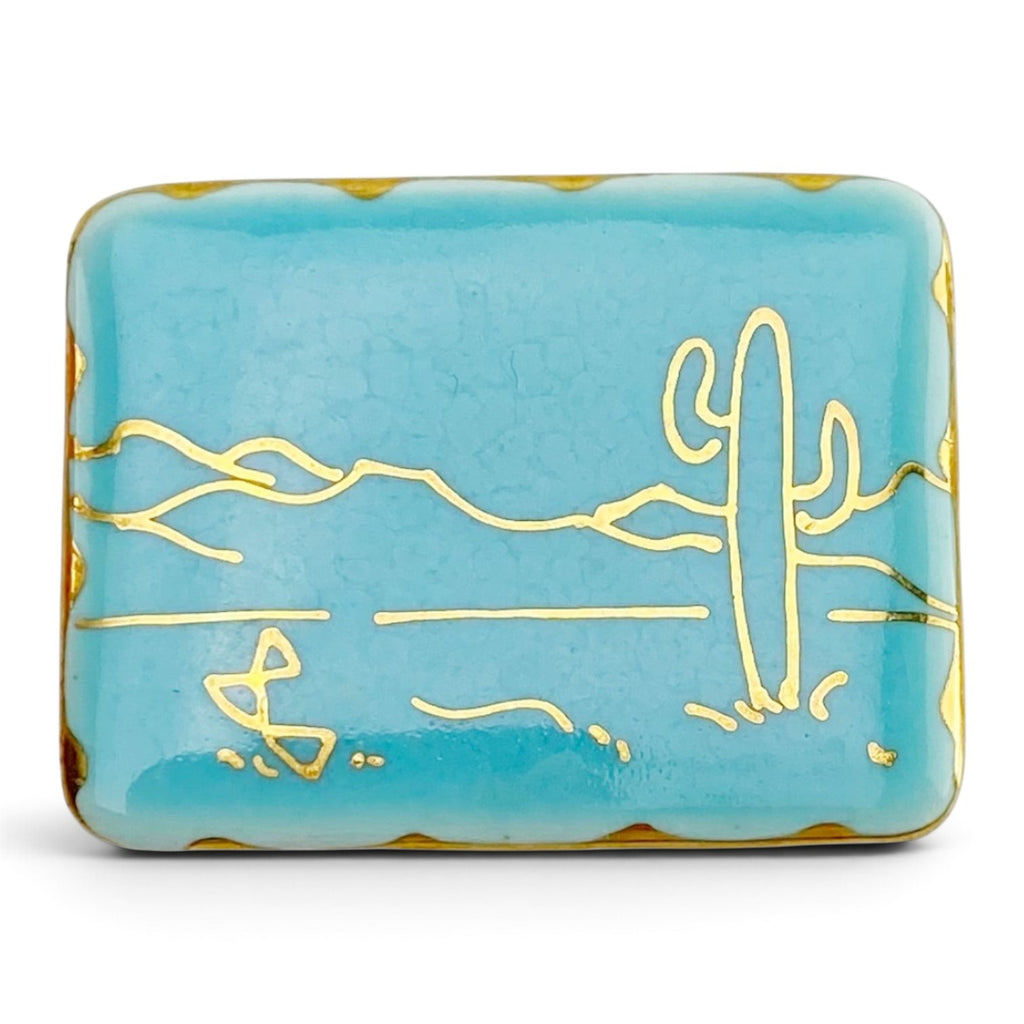 FuzzBeez vintage turquoise ceramic brooch with gold saguaro cactus line art and scalloped edges.