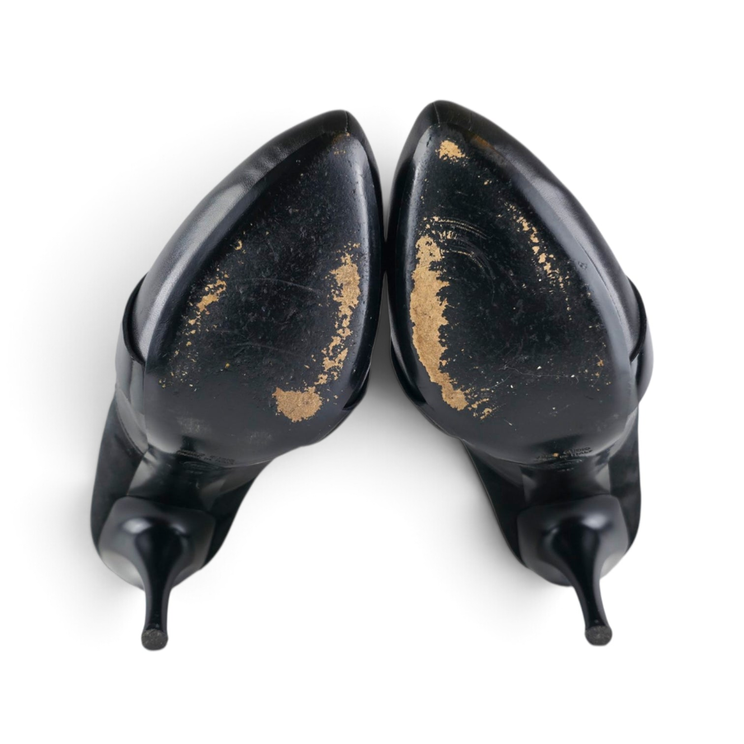 FuzzBeez Viktor & Rolf black leather and suede stiletto pumps showing worn leather soles from a top-down view
